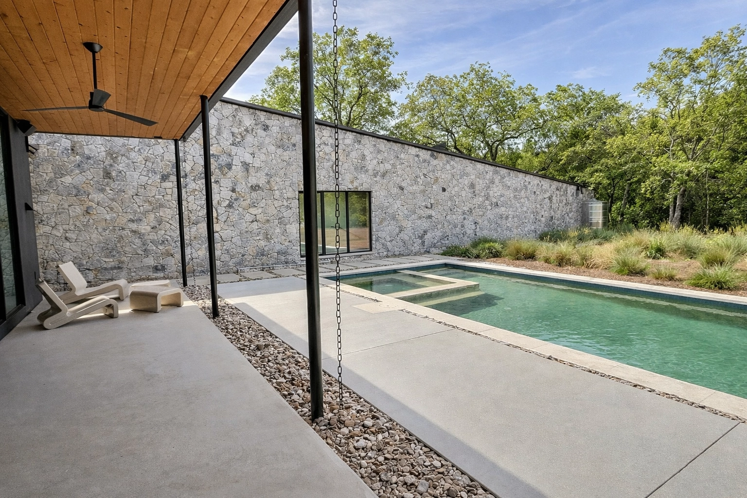 dwell_best_construction_austin_TX_home_builder_custom_new_modern_stone_wall_pool_murray_legge