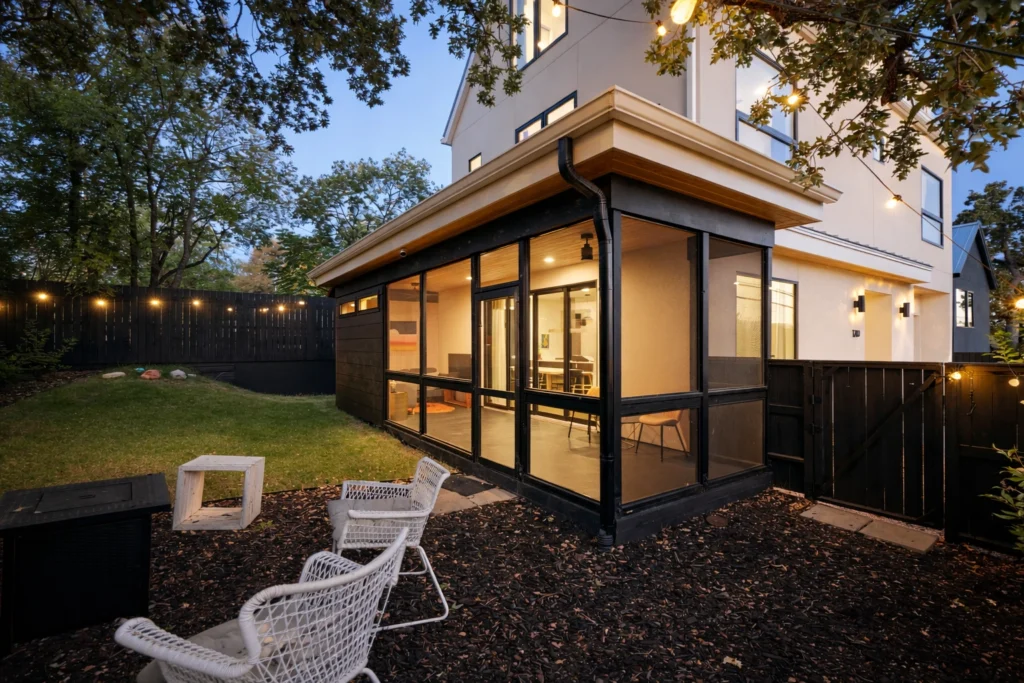 Screened patio addition with modern black-framed windows