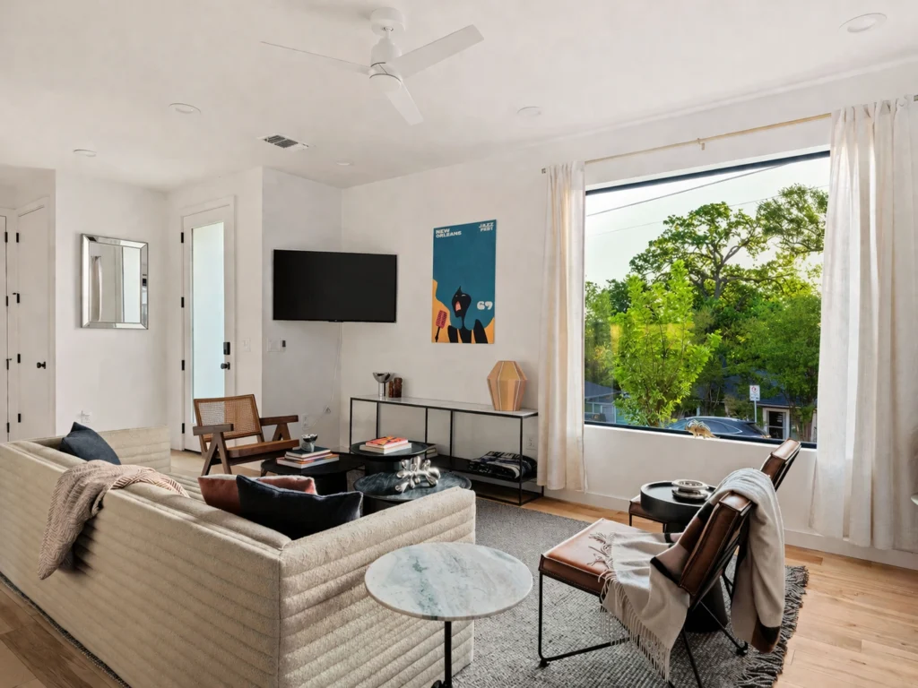 Bright modern living room with oversized black-framed windows