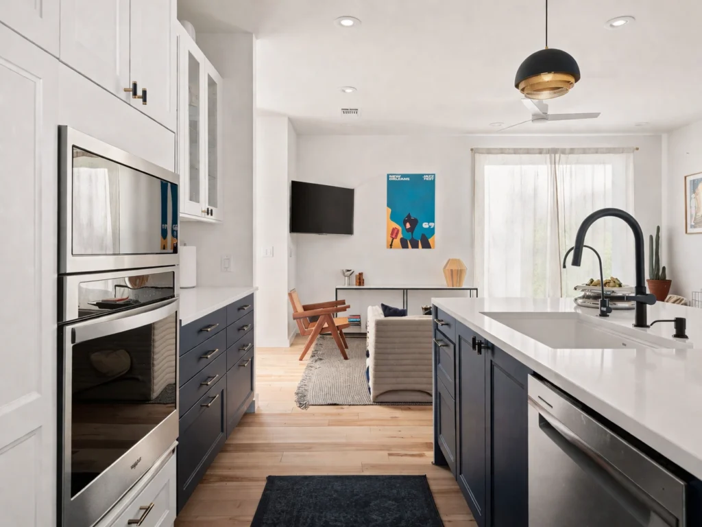 Modern kitchen with navy lower cabinets and white quartz countertops