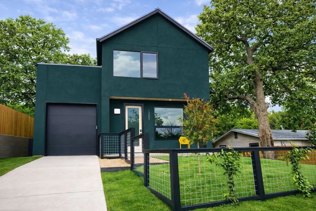 Modern dark green custom home exterior with minimalist architectural design