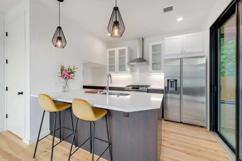 Contemporary kitchen remodel with white cabinetry and waterfall island