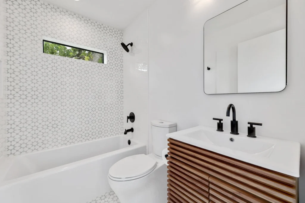 Contemporary bathroom with floating wood vanity and hexagon tile wall