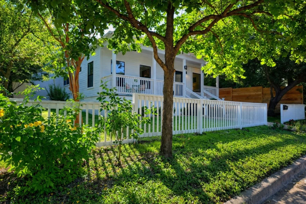 Contemporary cottage-style home renovation with landscaped front yard and mature trees