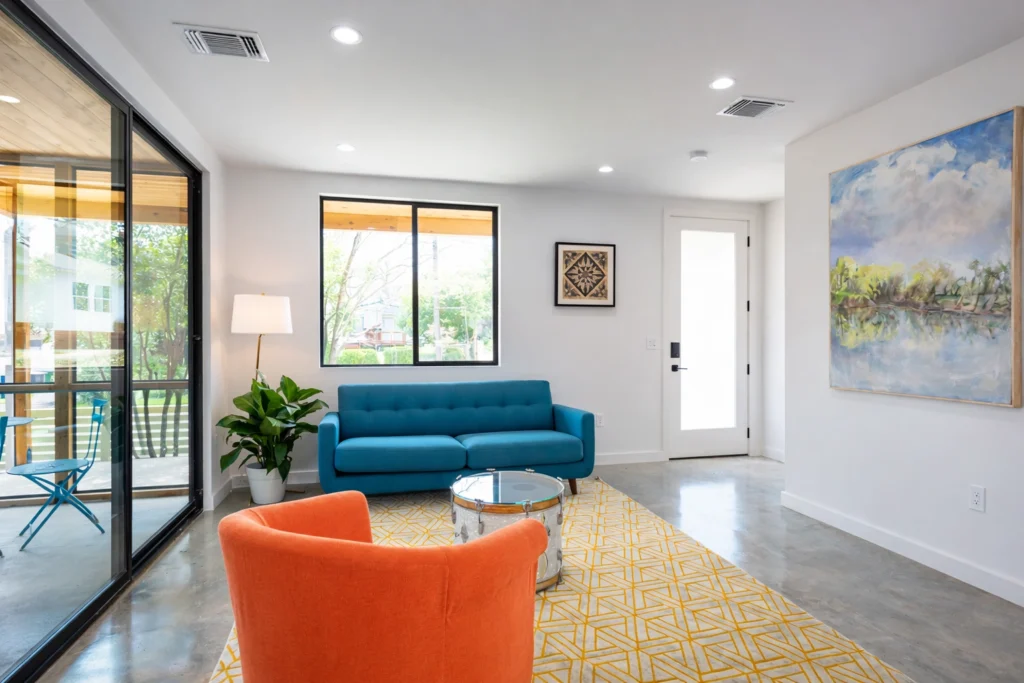 Contemporary living room with blue sofa and natural light