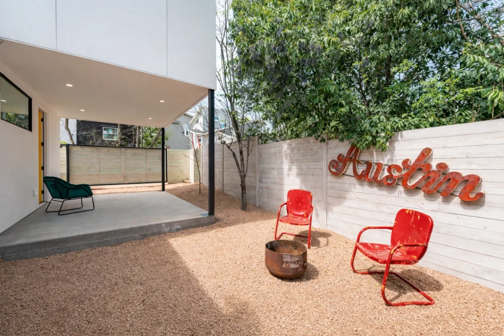 Modern outdoor patio area with Austin mural and landscaping