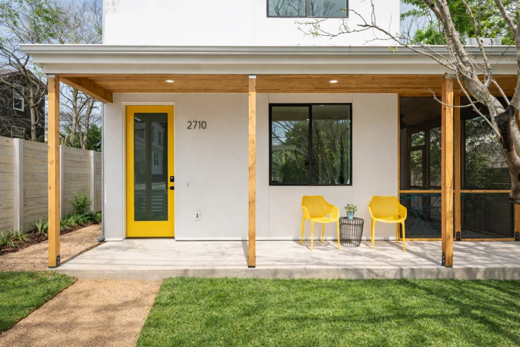 Modern farmhouse exterior with covered patio and black-framed windows