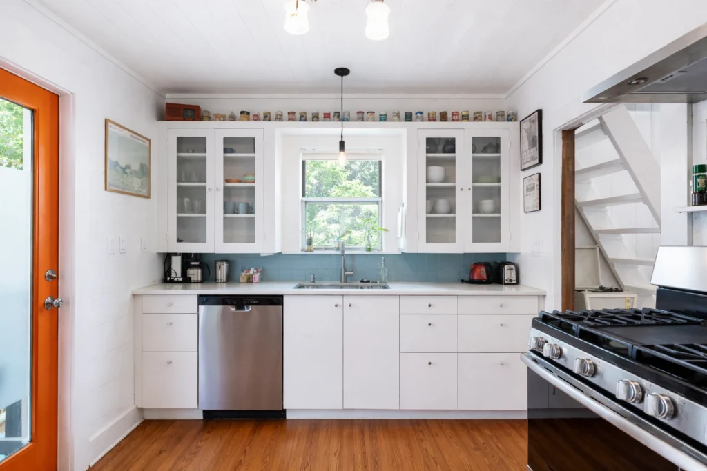 Compact kitchen remodel with white cabinetry and modern appliances